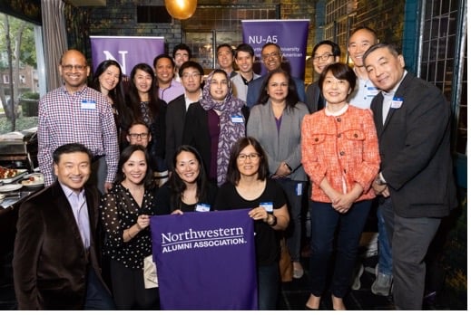 Alumni standing together for a photo